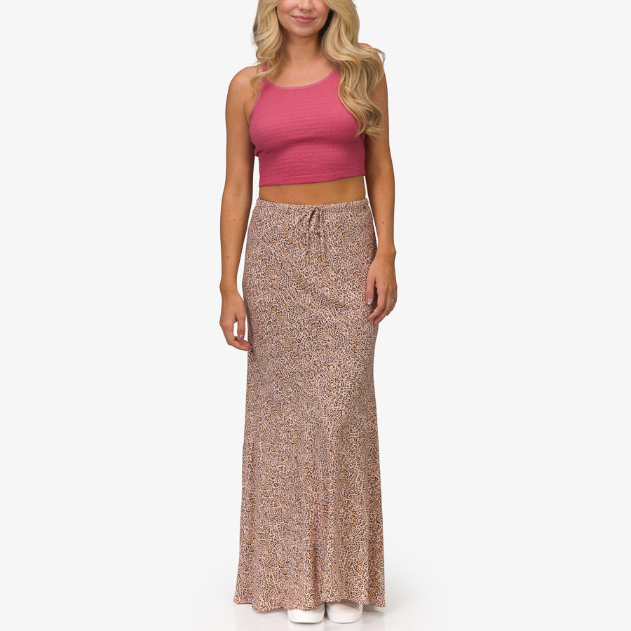 Woman wearing a Sandy Maxi Skirt with a rose animal print, front view, styled for beach and everyday comfort.