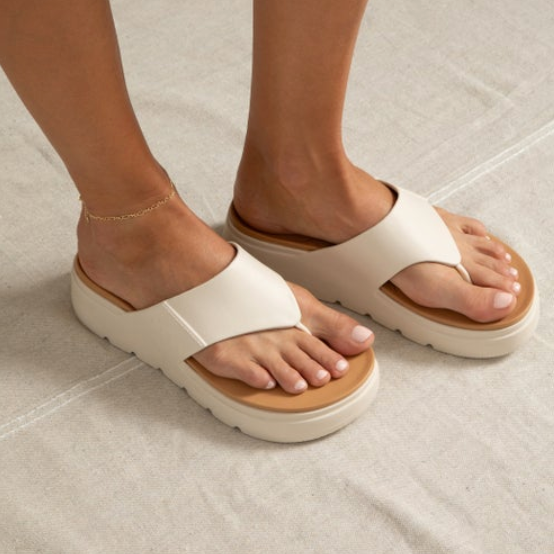 Close-up of feet wearing right-facing Cali Laguna platform sandals with extra cushioning and enhanced arch support in neutral tones.