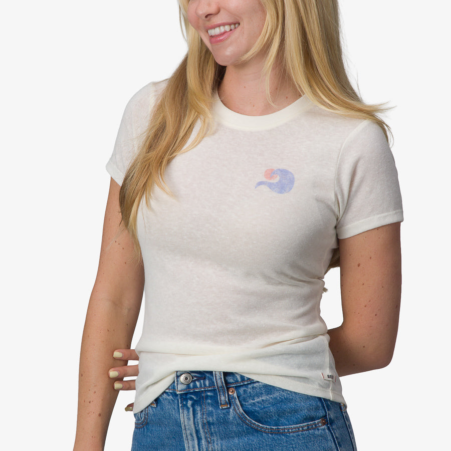 Woman wearing a marshmallow colored Surf Club Fitted Tee, front view showing soft fabric and beach-inspired design.