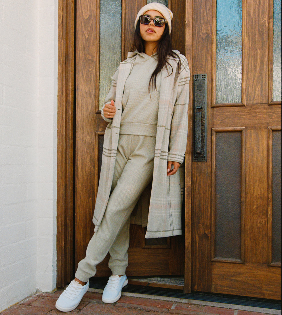 Woman wearing Tina Thermal Jogger in desert sage, front view with soft-rebound cushioning and arch support shoes.
