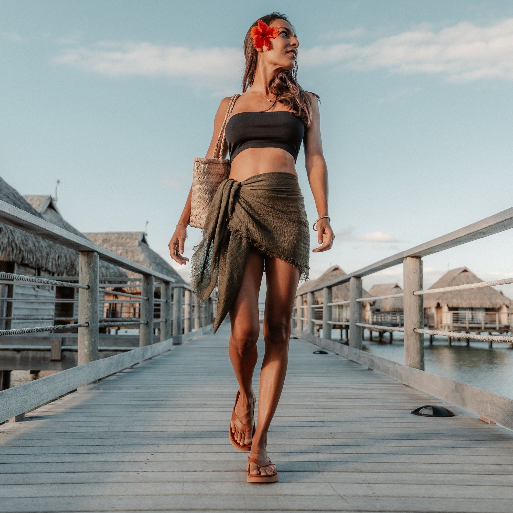 Woman walking on boardwalk wearing Vista Luxe Vivianahh sandals facing forward, showcasing beach-inspired comfort style.