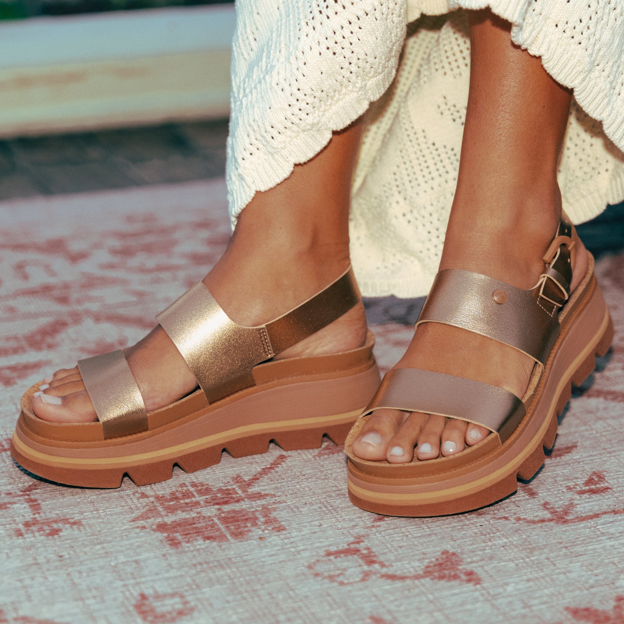 Vista Luxe Liah sandals facing forward, close-up of front and side straps in sunset bronze with cushioned platform soles.