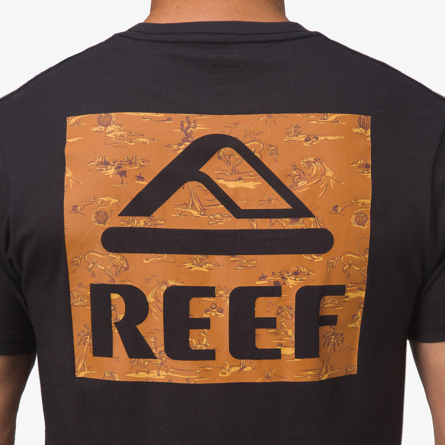 Back view of men's black Wayne Tee with large orange REEF logo panel featuring beach-inspired designs and comfort focus.