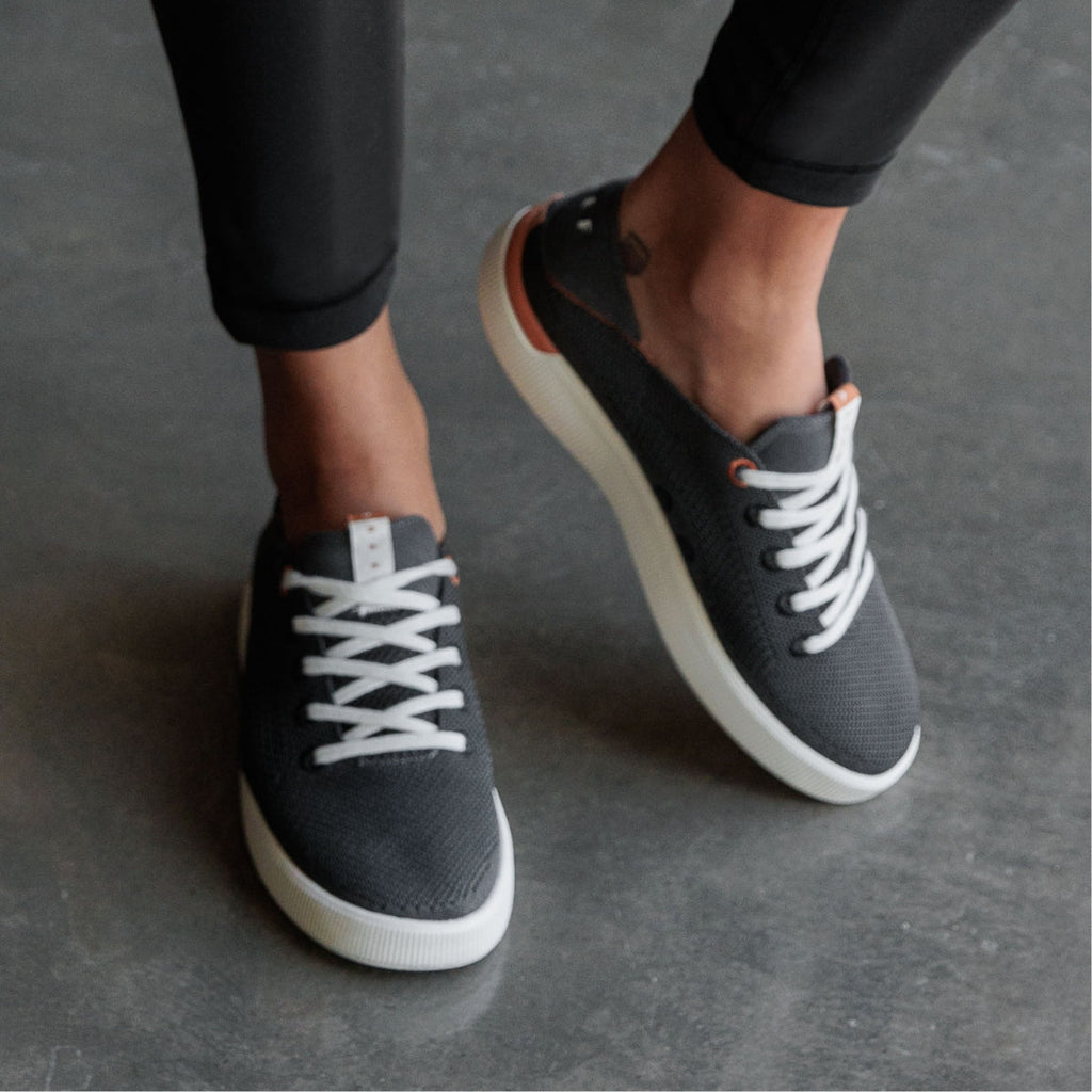 Close-up of black Reef Neptune sneaker facing forward, featuring anatomical arch support and soft-rebound cushioning for women.