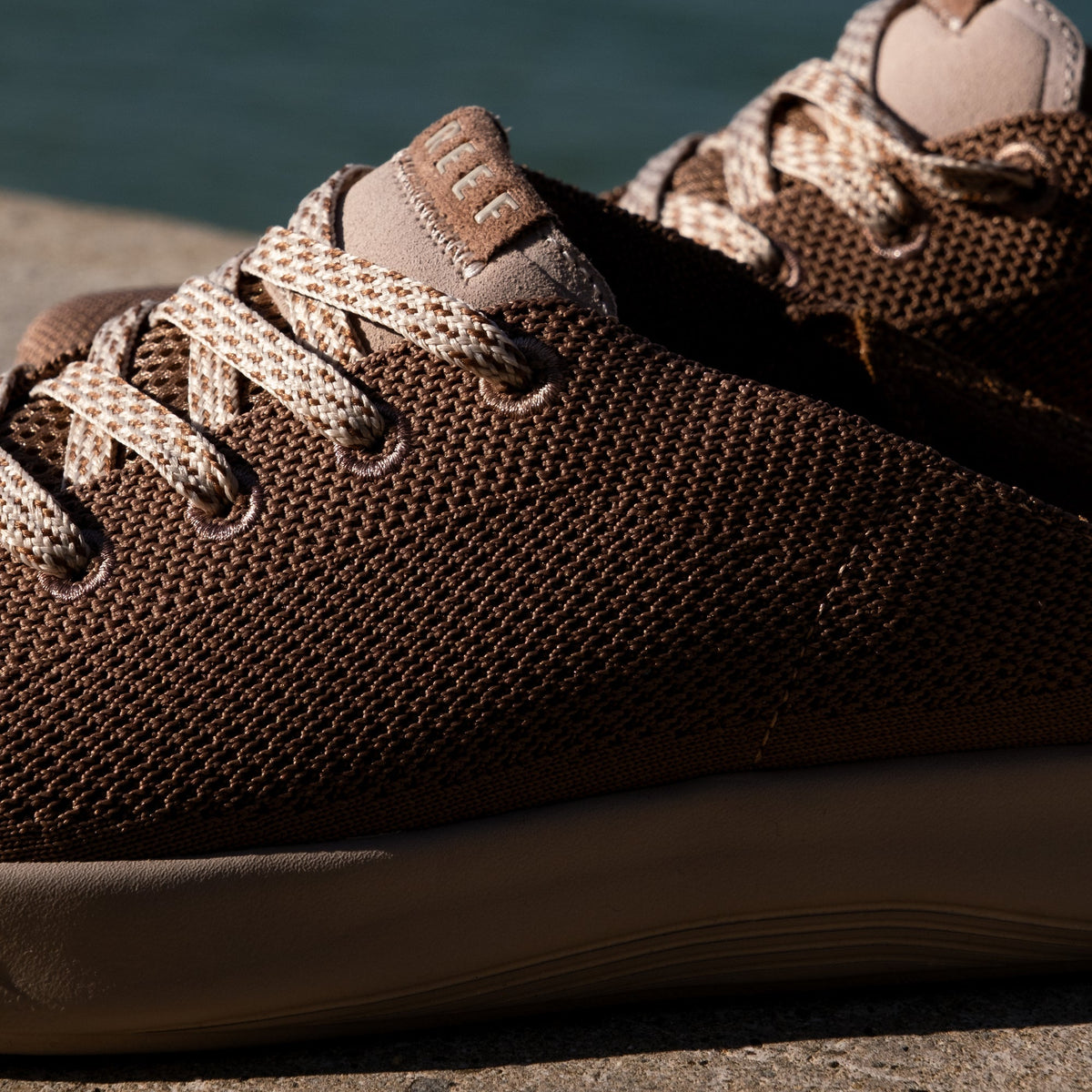 Close-up of the left side of the Neptune shoe for men, showing breathable knit upper and lace details facing right.